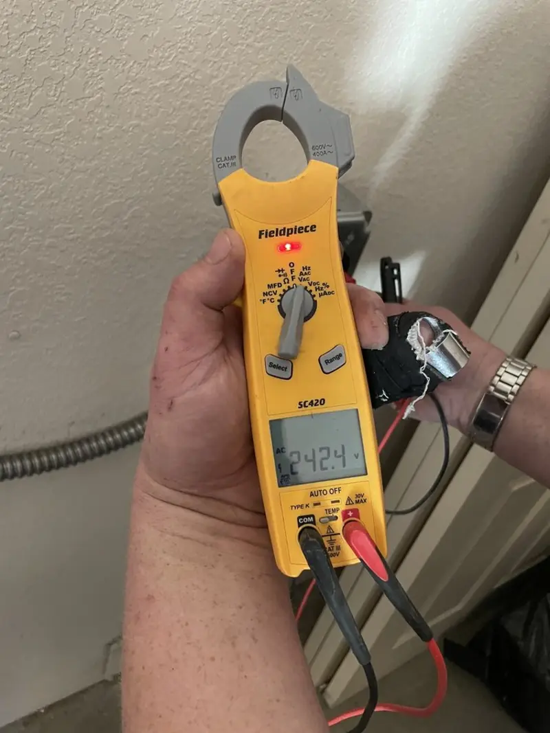 Voltage testing with clamp meter during Outlet Installation in Lynn